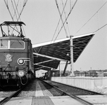 854529 Gezicht op het in aanbouw zijnde nieuwe N.S.-station Tilburg te Tilburg, met links de electrische locomotief nr. ...